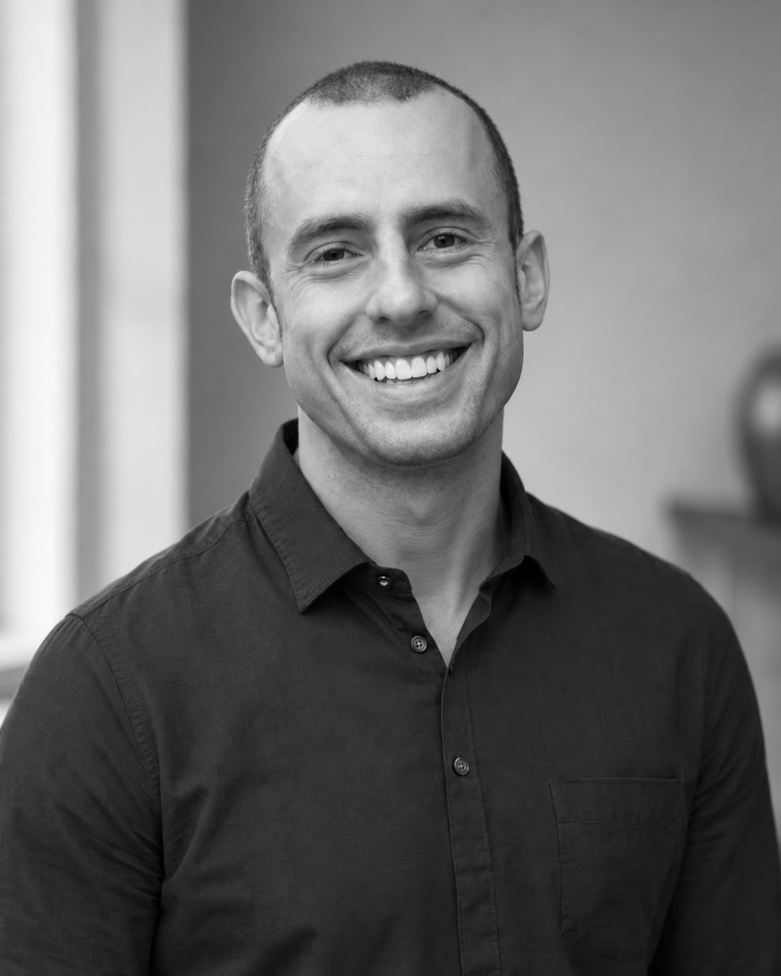 Jonathan Bailor smiling in a black-and-white author portrait.